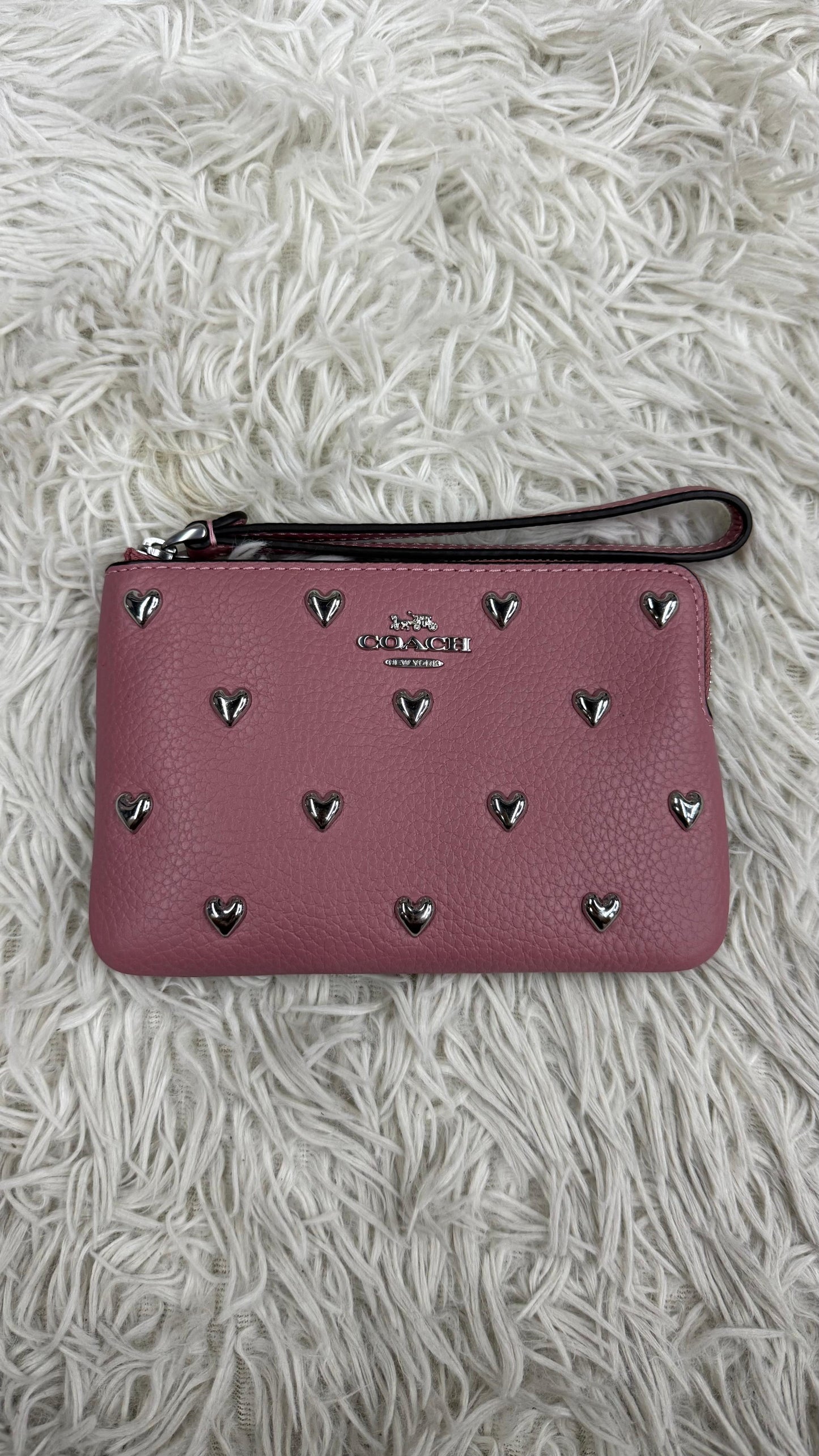 Muñequera rosa Coach