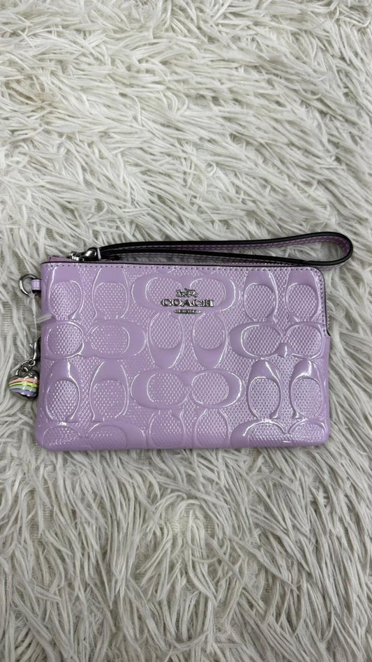 Muñequera lila Coach