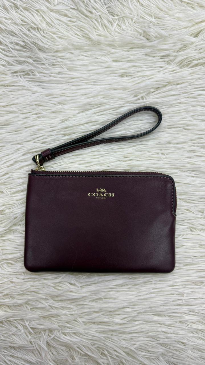 Muñequera vino Coach